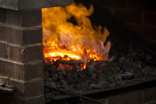 Heating a horse shoe in a coke fueled forge
