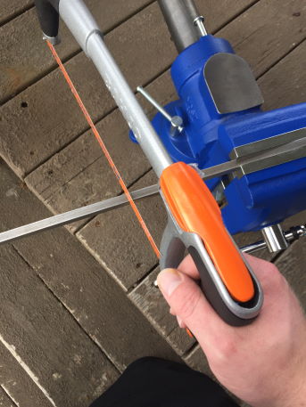 cutting steel in a vice with a hacksaw