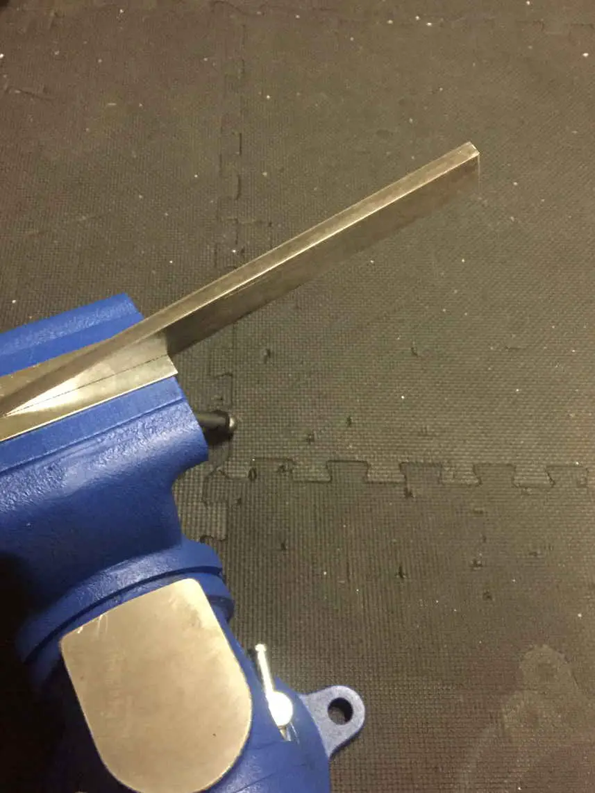 An image of a vise holding a piece fo 1018 steel bar stock