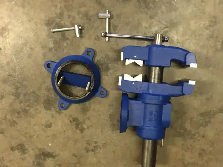 an image of a disassembled multi jaw swivel vise