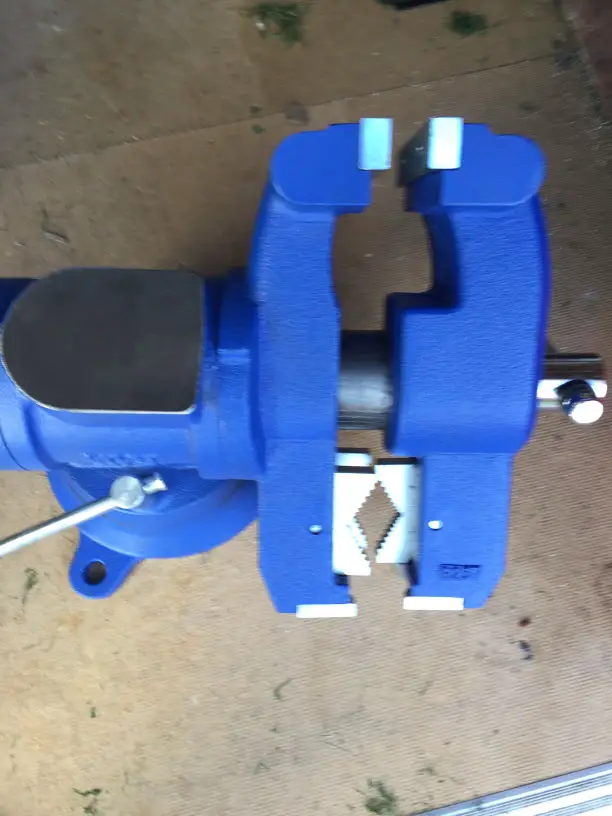 an image of a multi jaw pipe vise on a shed floor